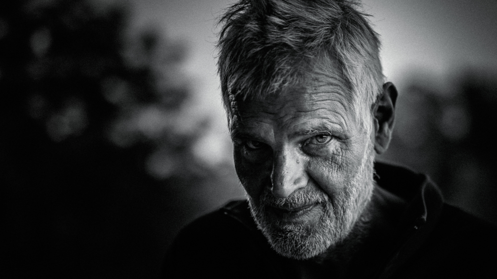 Older man reflecting during men's personal growth counselling