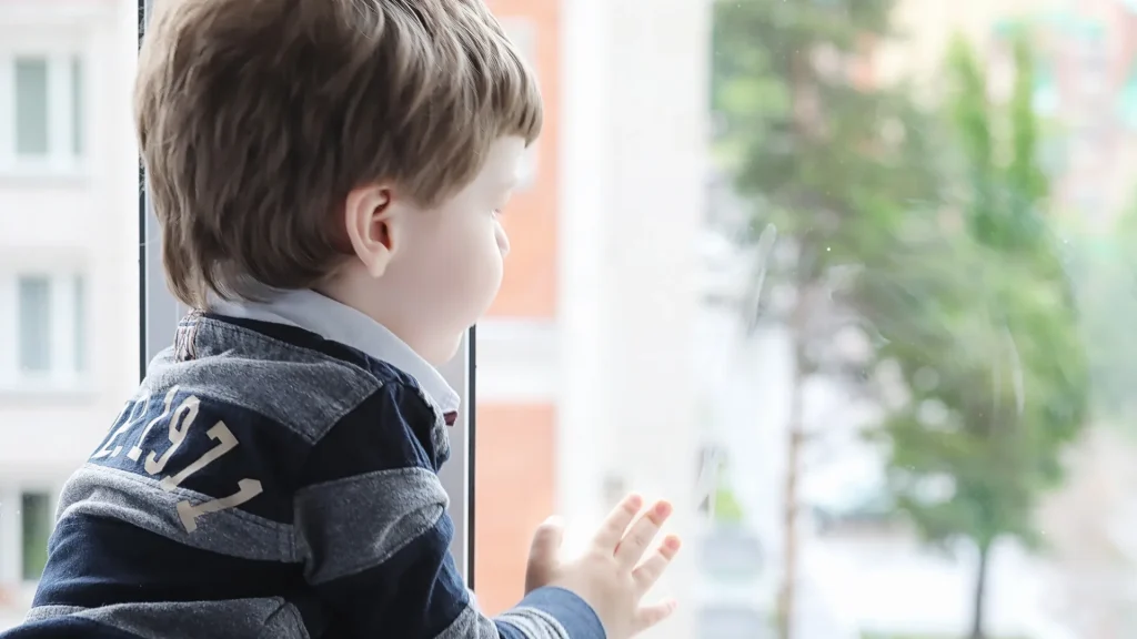 Boy looking out window