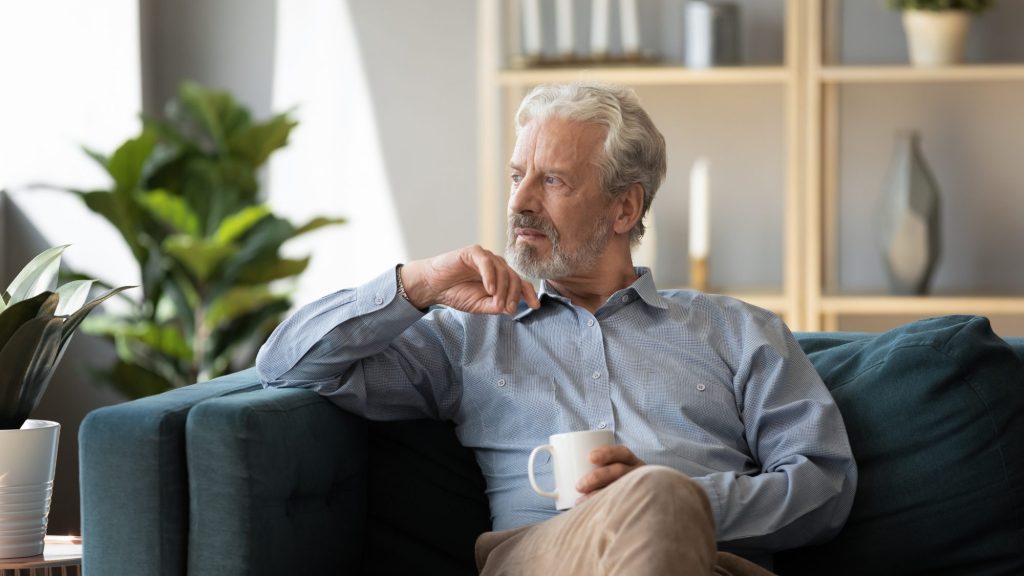 high functioning depression in men successful older man sitting alone feeling emotionally disconnected