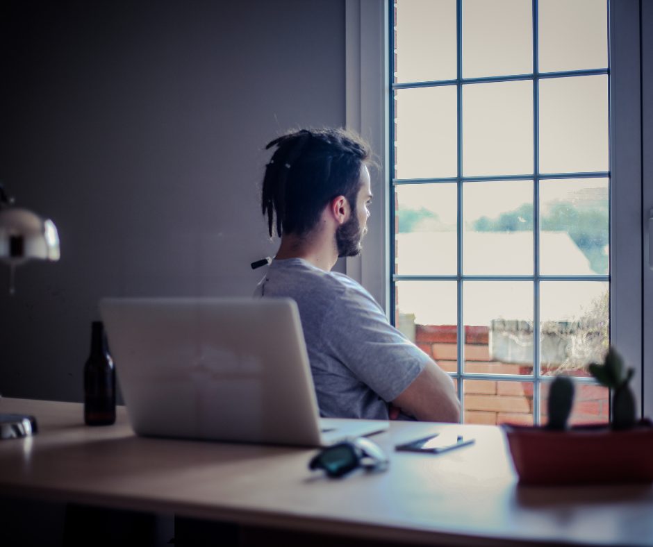 Person sitting alone by a window, reflecting — representing the experience of anxiety and depression